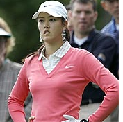 Image of Michelle Wie in pink shirt wearing a white cap.PNG